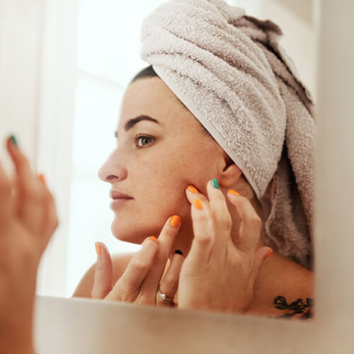 woman looking at mirror